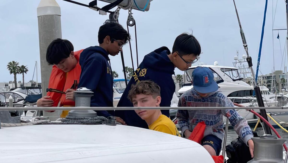 Kids rigging a sailboat.