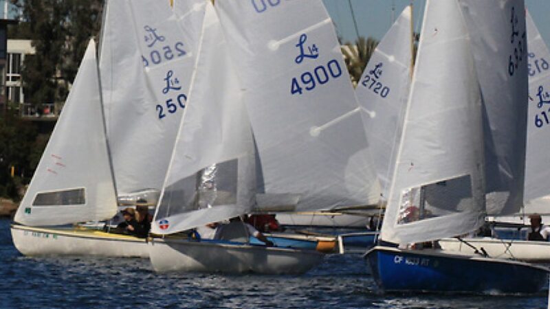a group of small sailboats on the water