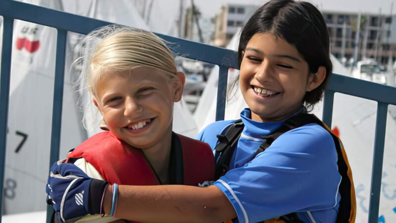 girls hugging, sailing teammates.