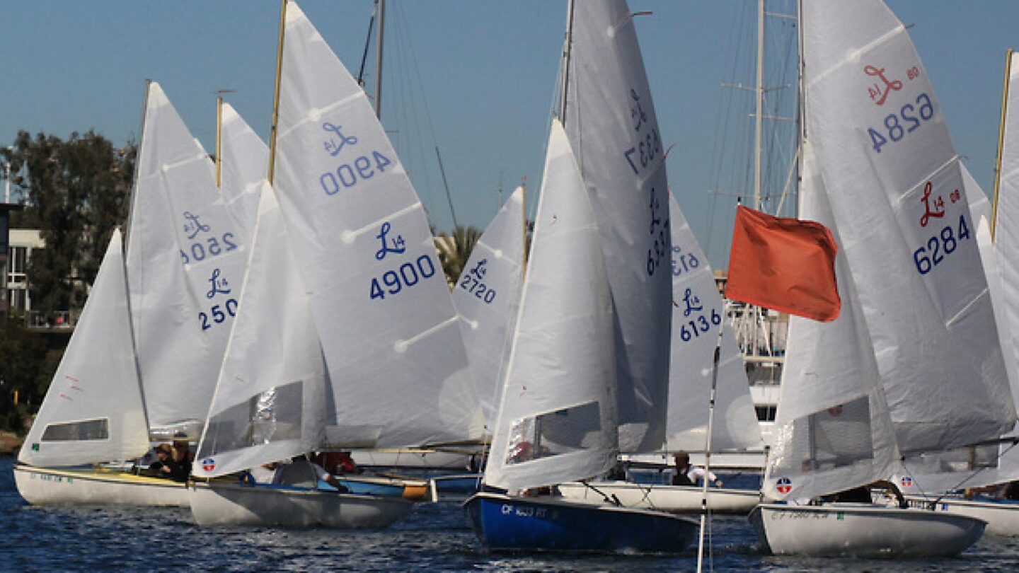 a group of small sailboats on the water