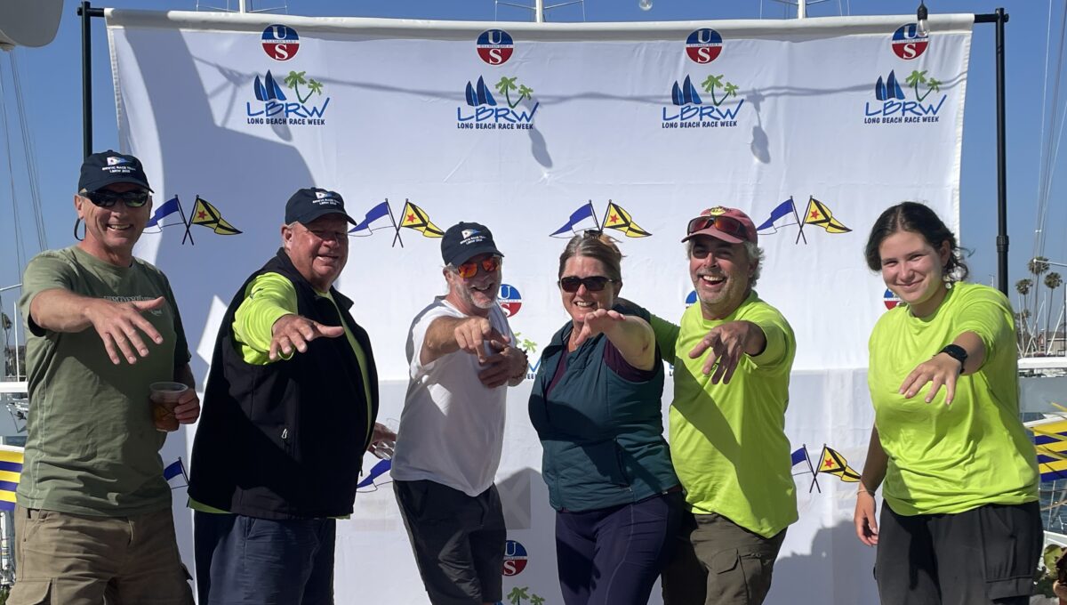 Six people hamming it up on the podium