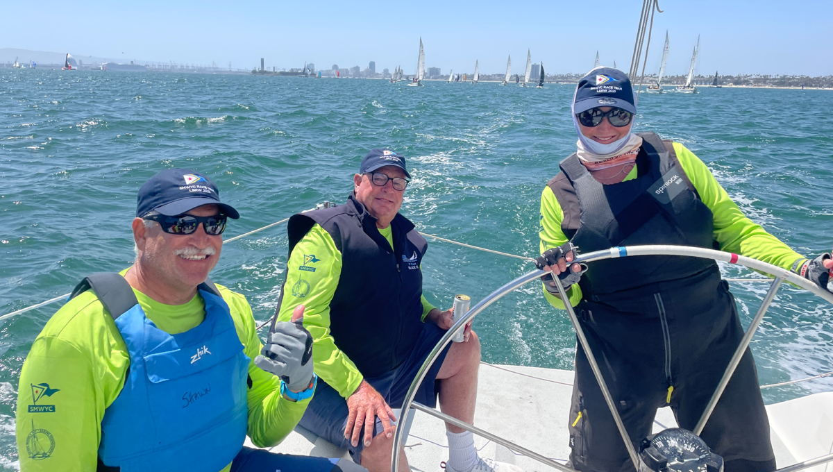 Three sailors on a boat in the ocean