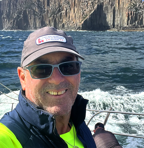 Doug Johnstone sailing along a very rocky coast.